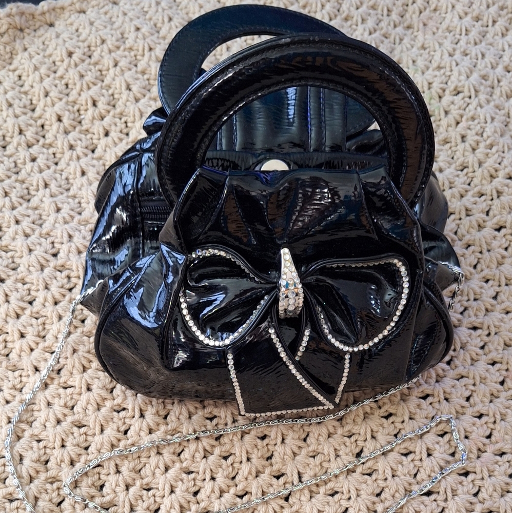 Elegant Black Handbag. Made of patent leather. It's missing a single shiny. Used